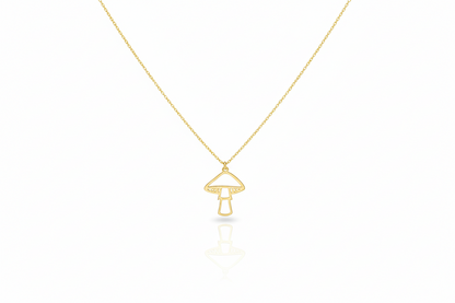 Gold necklace with a mushroom pendant on a white background