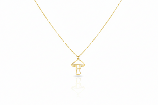 Gold necklace with a mushroom pendant on a white background