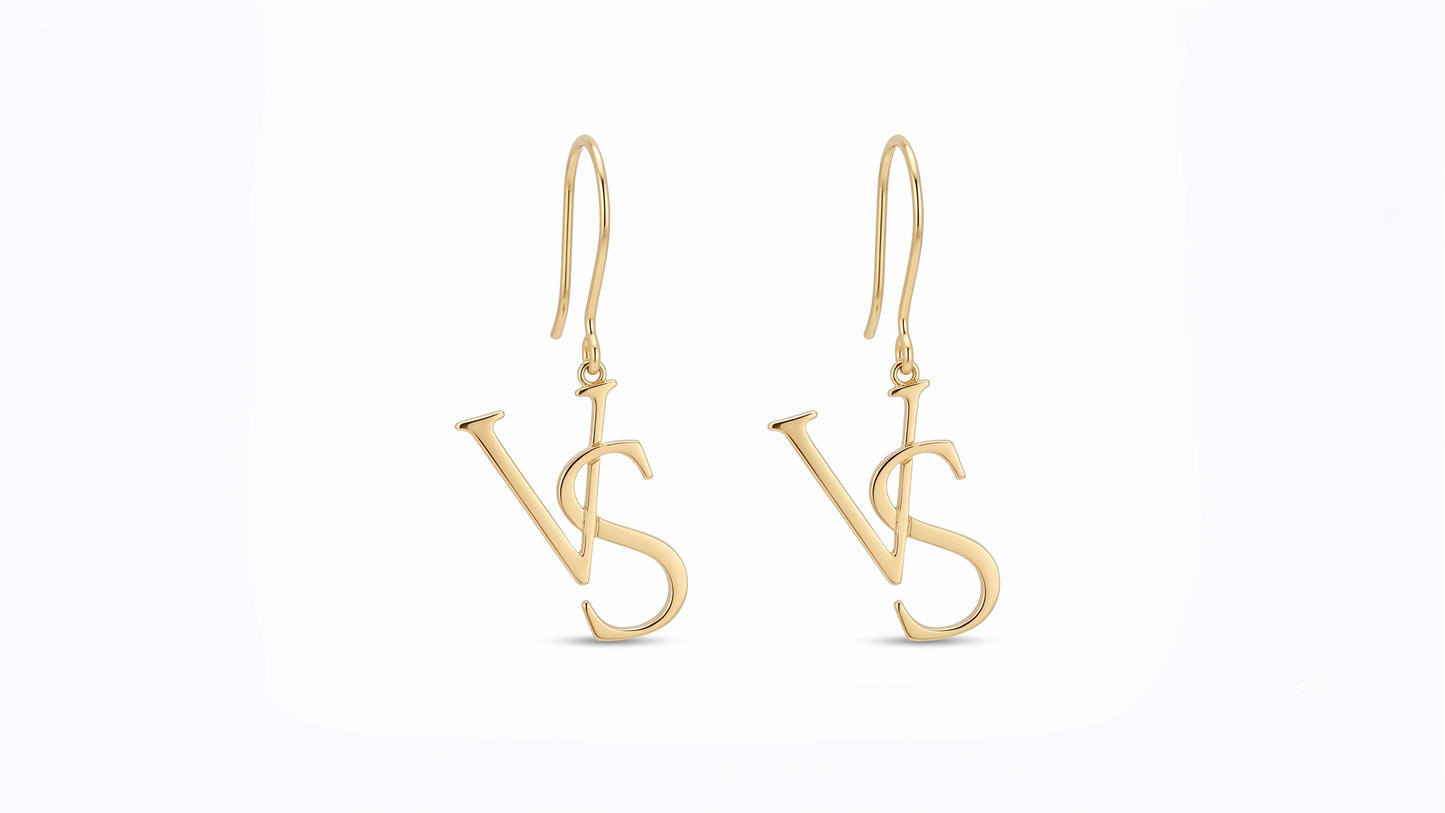 A pair of gold drop earrings featuring a stylized interlocking 'VS' monogram design, suspended from classic fishhook wires on a clean white background.