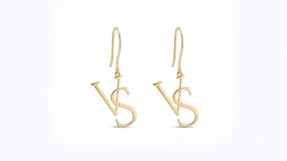A pair of gold drop earrings featuring a stylized interlocking 'VS' monogram design, suspended from classic fishhook wires on a clean white background.