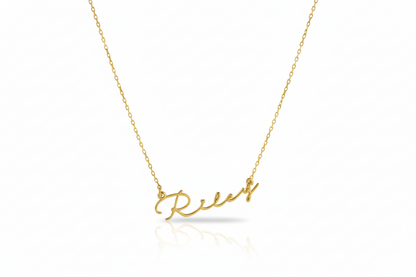 Gold necklace with 'Relax' pendant on a white background