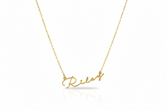 Gold necklace with 'Relax' pendant on a white background