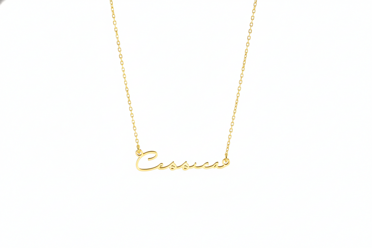 Gold necklace with 'Cassie' pendant on a white background