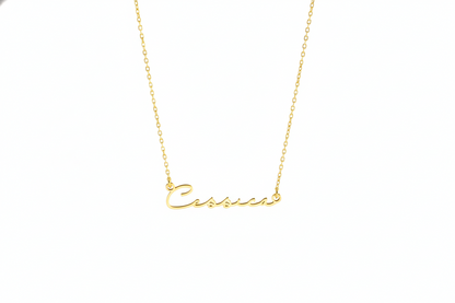 Gold necklace with 'Cassie' pendant on a white background
