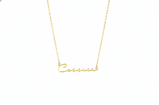 Gold necklace with 'Cassie' pendant on a white background