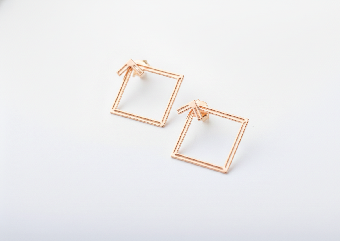 Rose gold square frame earrings on a white background