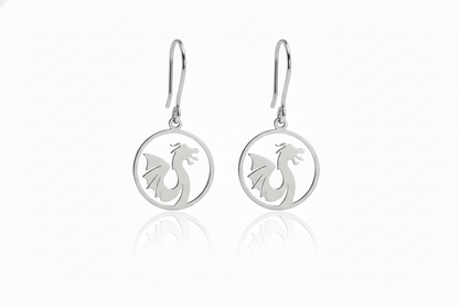 Silver earrings with dragon design on a white background