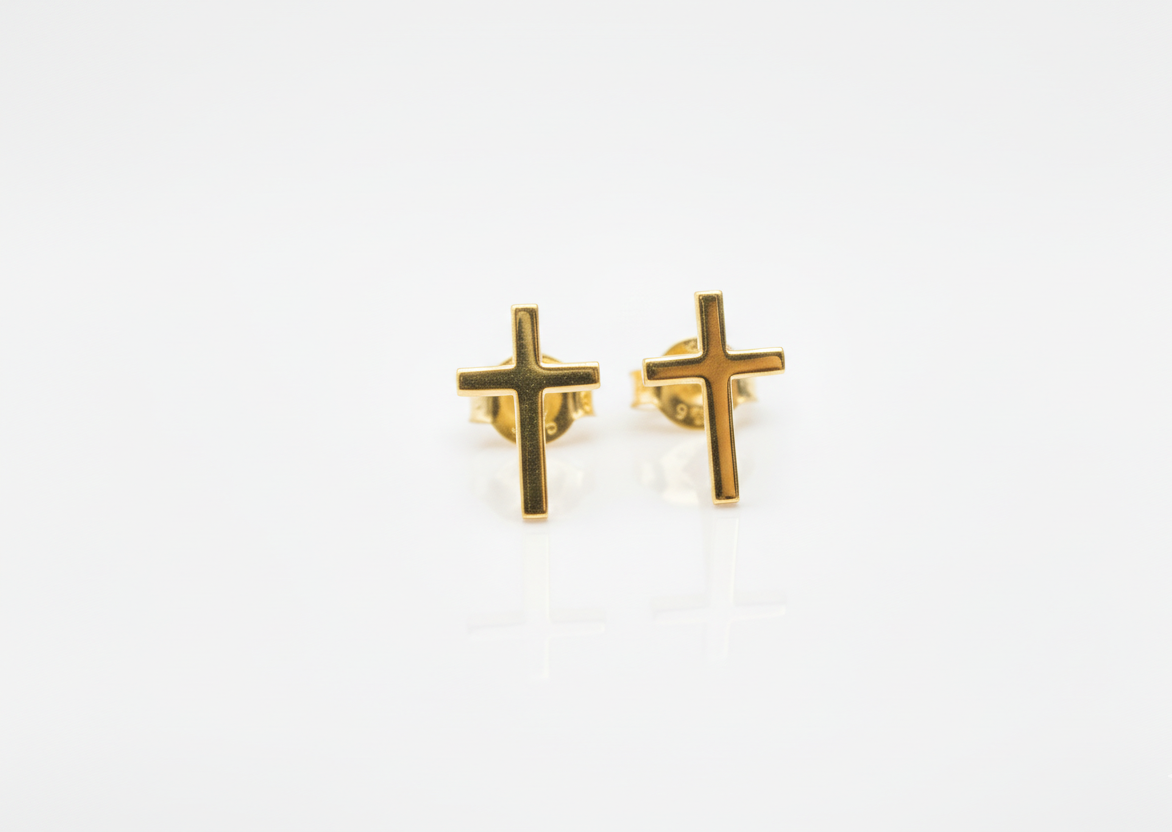 Gold cross-shaped earrings on a white background