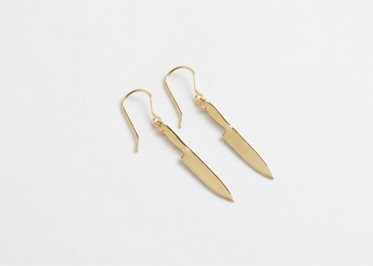 Gold earrings on a white background