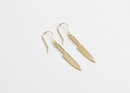 Gold earrings on a white background