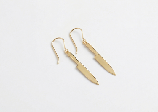 Gold earrings on a white background
