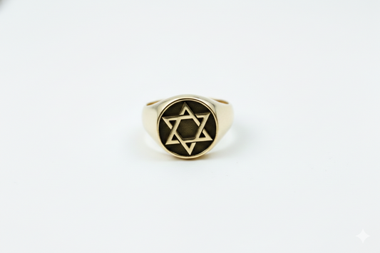 Gold ring with Star of David on a white background