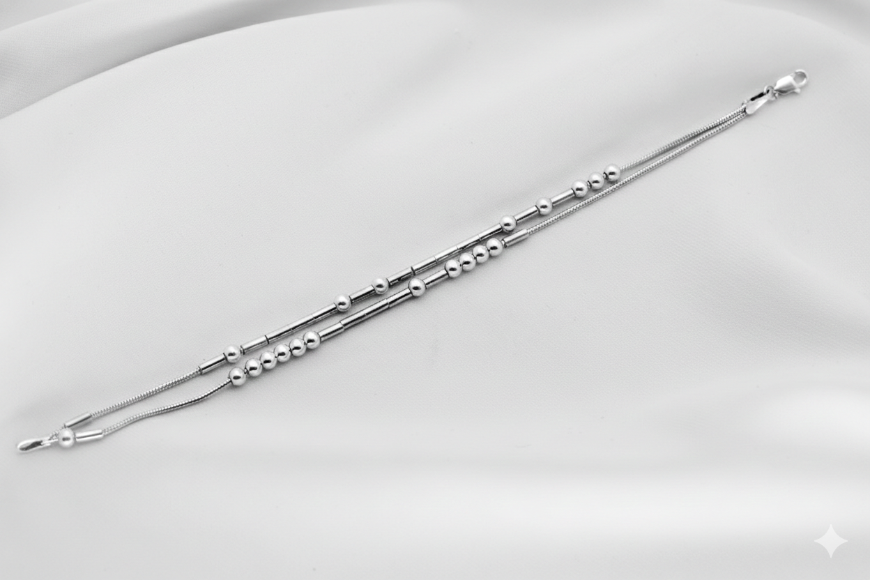 Silver bracelet with beads on a white background