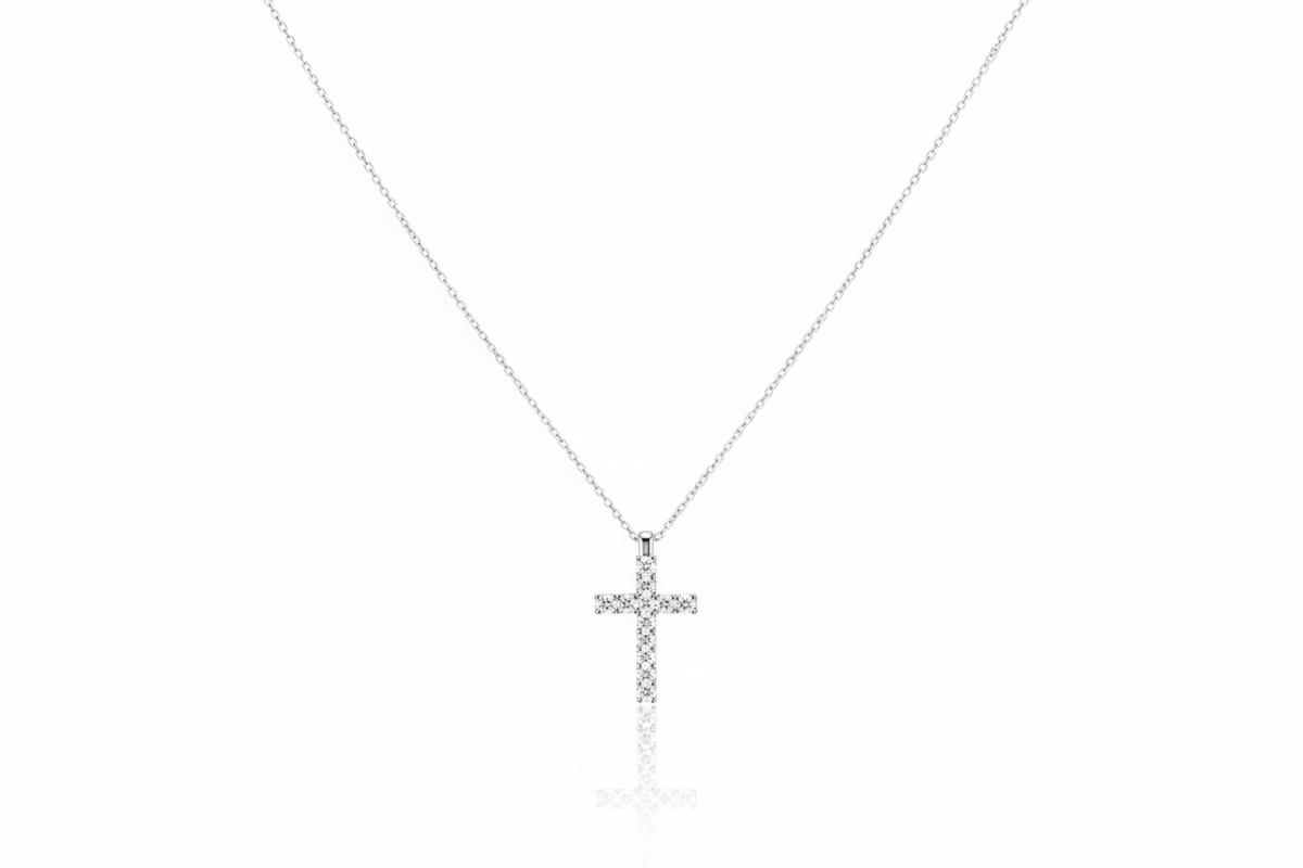 Silver cross necklace on a white background
