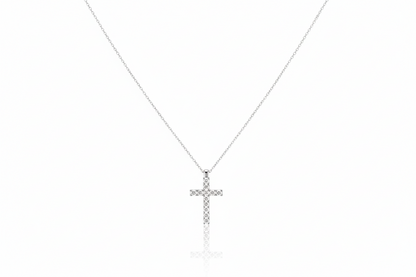 Silver cross necklace on a white background
