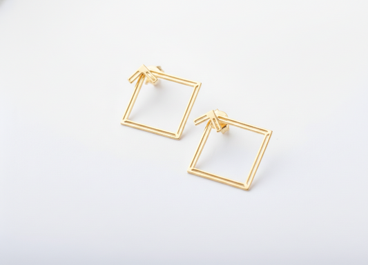 Gold square hoop earrings on a white background