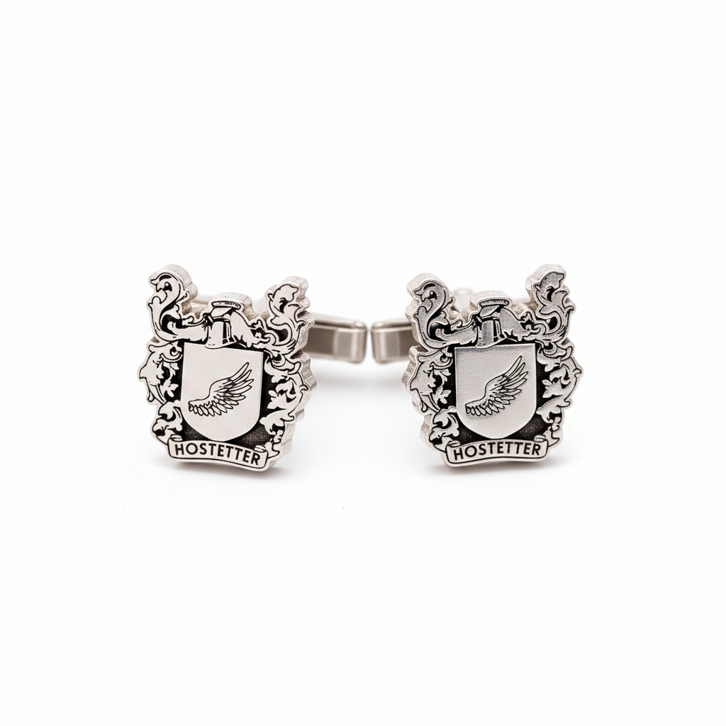 Silver cufflink with crest design on a white background