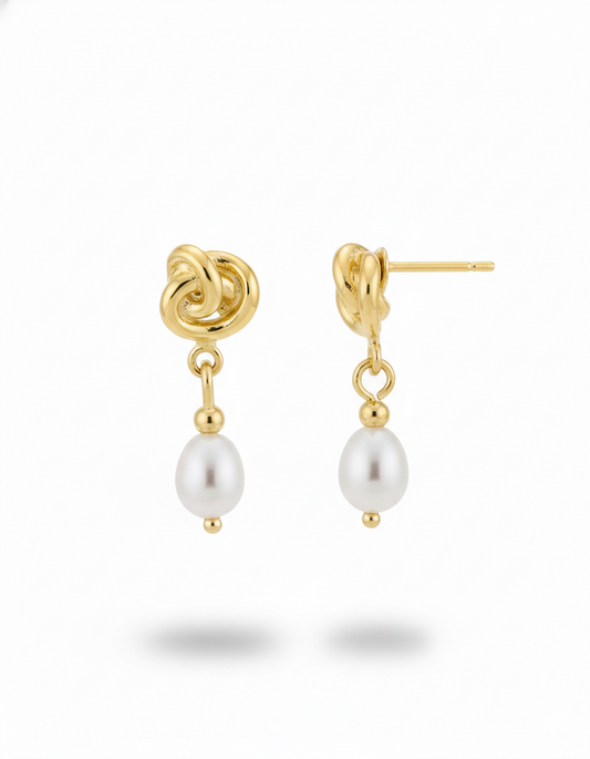 Gold knot earrings with pearl drops on a white background