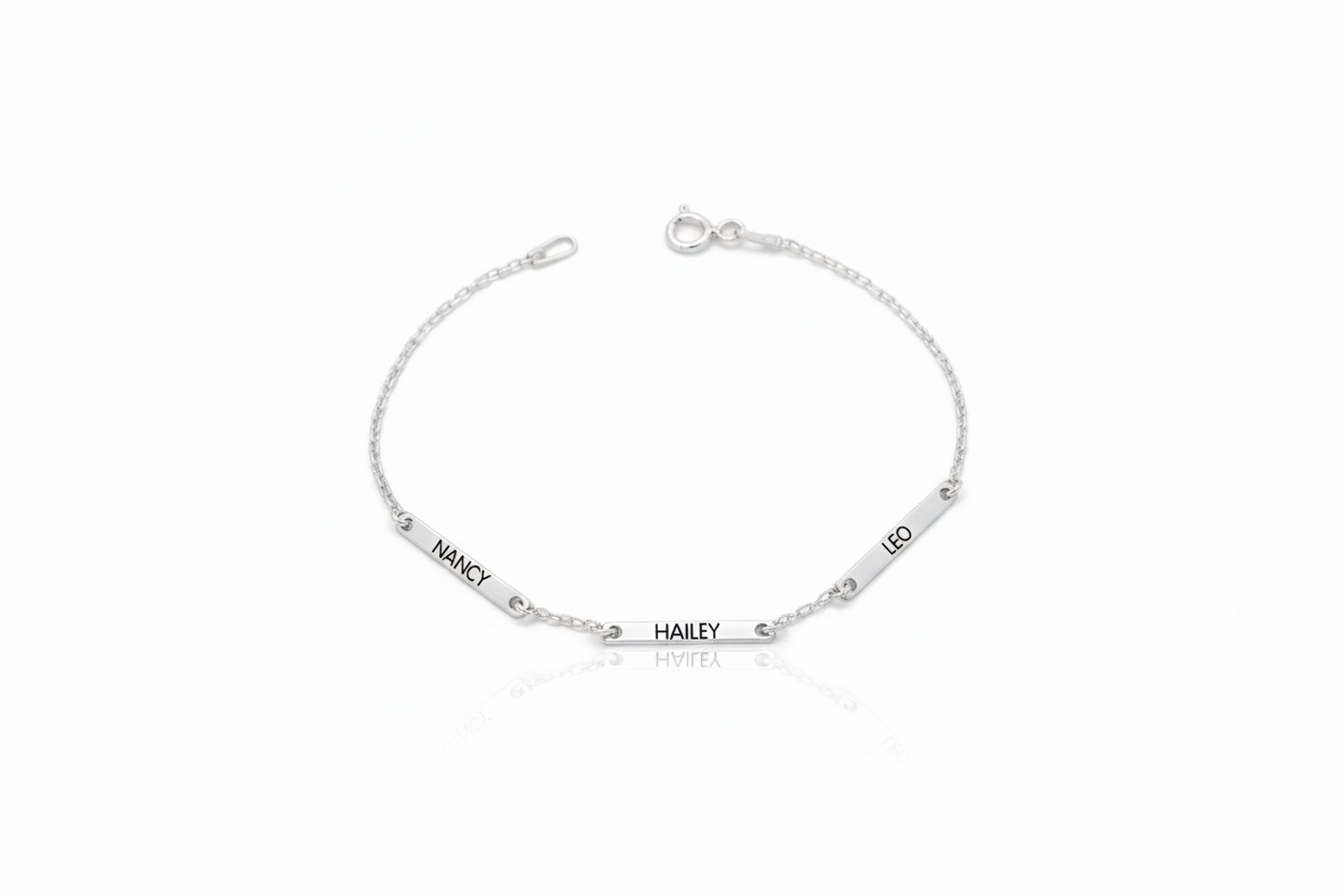 Silver bracelet with engraved names on a white background