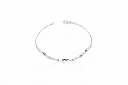 Silver bracelet with engraved names on a white background