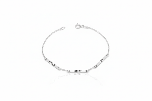 Silver bracelet with engraved names on a white background