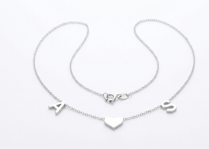 Silver bracelet with letter charms on a white background