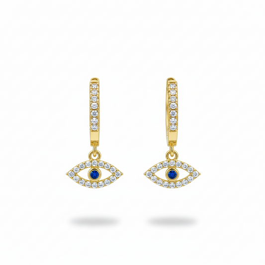 Gold earrings with eye design and blue gemstones on a white background