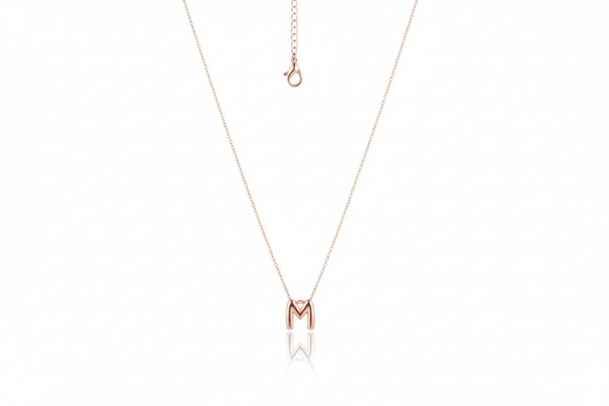 Rose gold necklace with a 'M' pendant on a white background