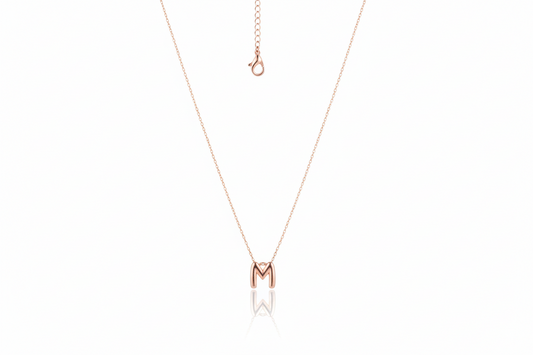 Rose gold necklace with a 'M' pendant on a white background