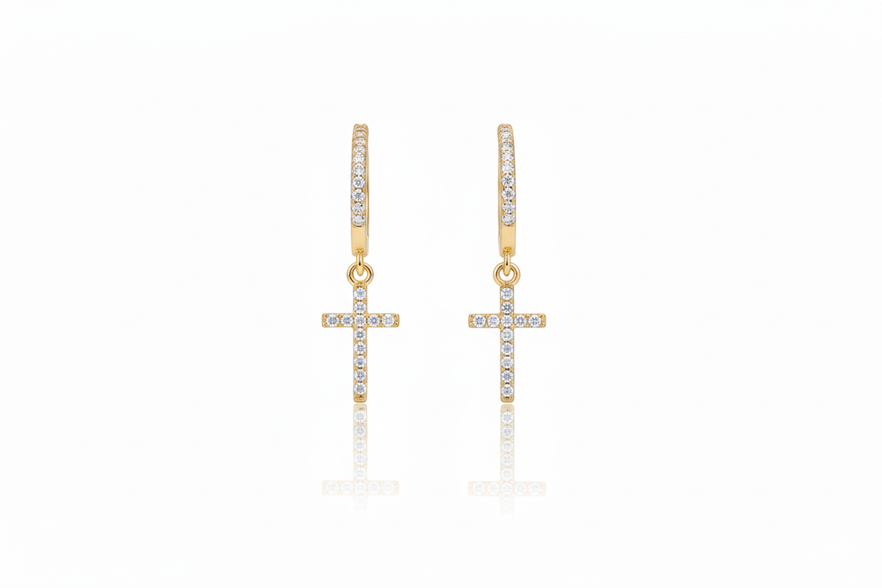 Gold cross earrings with clear stones on a white background