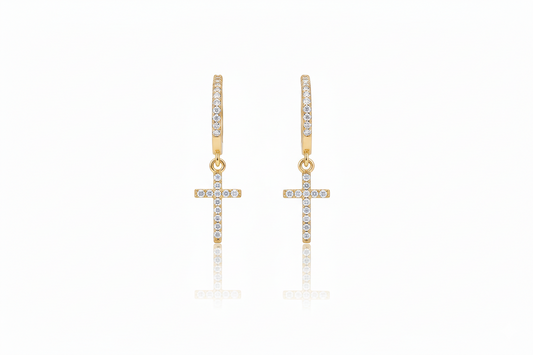 Gold cross earrings with clear stones on a white background
