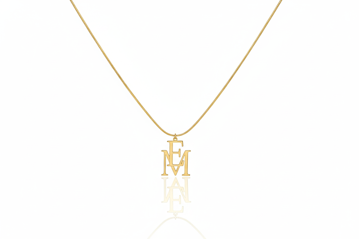 Gold necklace with 'EM' pendant on a white background