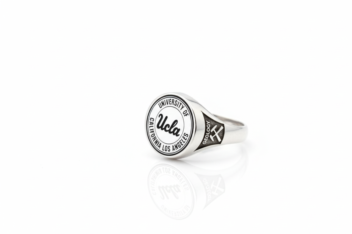 Silver ring with UCLA logo on a white background