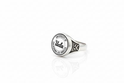 Silver ring with UCLA logo on a white background