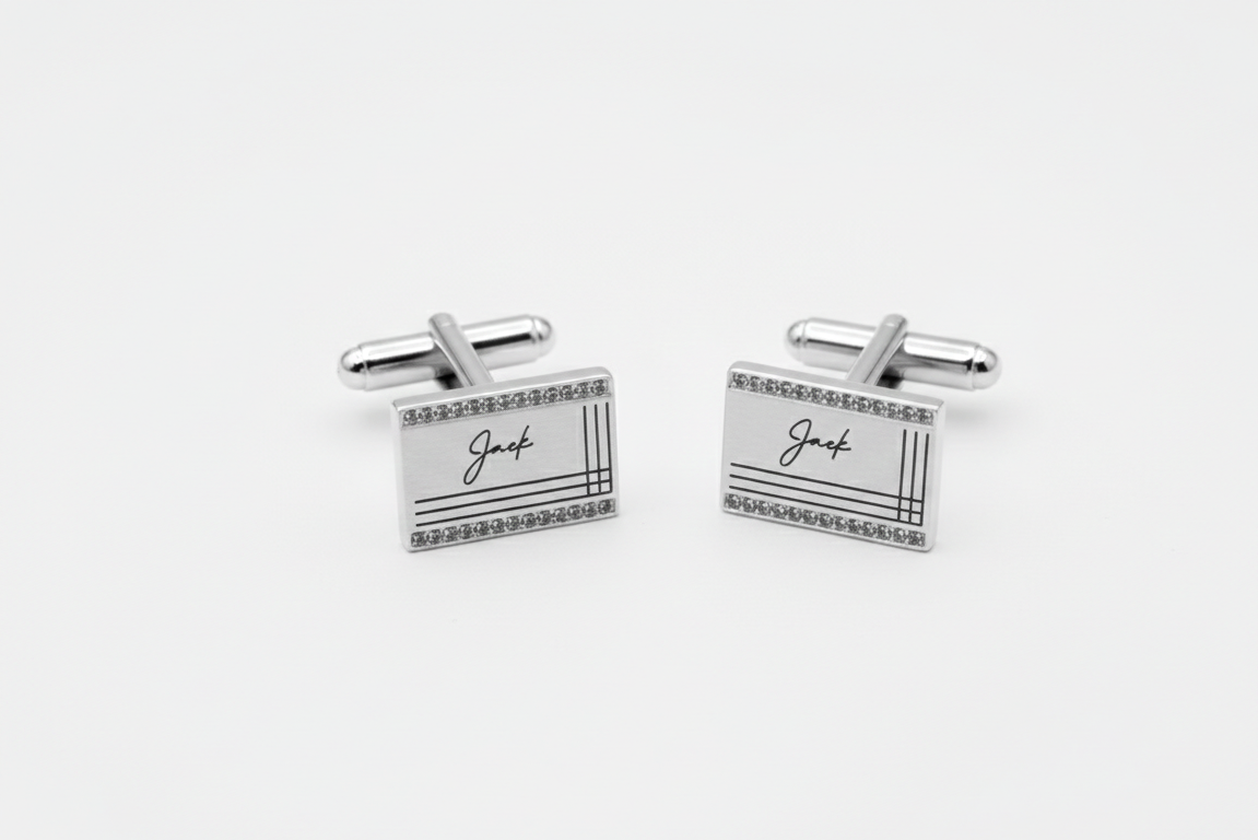 Pair of silver rectangular cufflinks with 'Jack' engraving on a white background