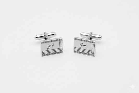 Pair of silver rectangular cufflinks with 'Jack' engraving on a white background