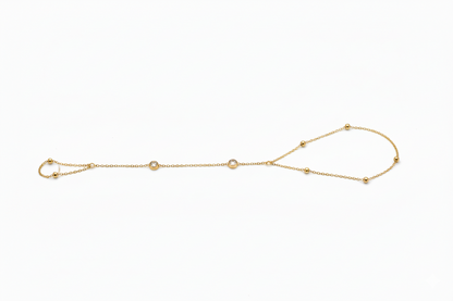 Gold bracelet with small beads on a white background