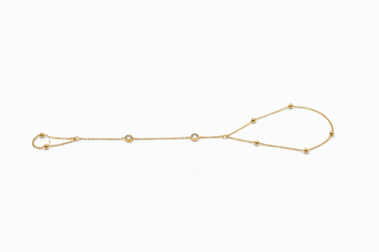 Gold bracelet with small beads on a white background