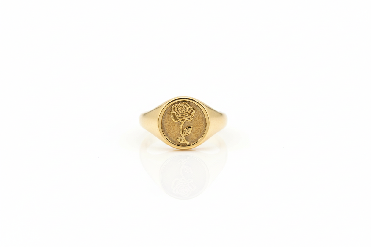 Gold ring with a rose design on a white background