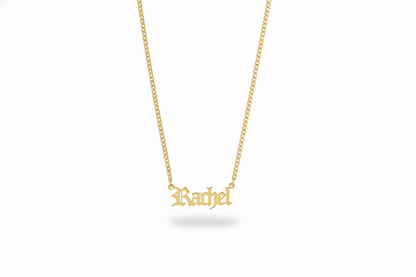 Gold necklace with 'Rachel' pendant with a dainty urb chain on a white background