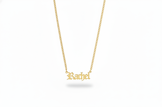 Gold necklace with 'Rachel' pendant with a dainty urb chain on a white background