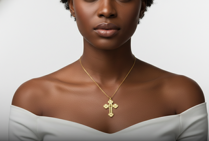 Woman wearing a gold necklace with a cross pendant on a neutral background