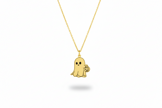 Gold ghost pendant necklace on a white background