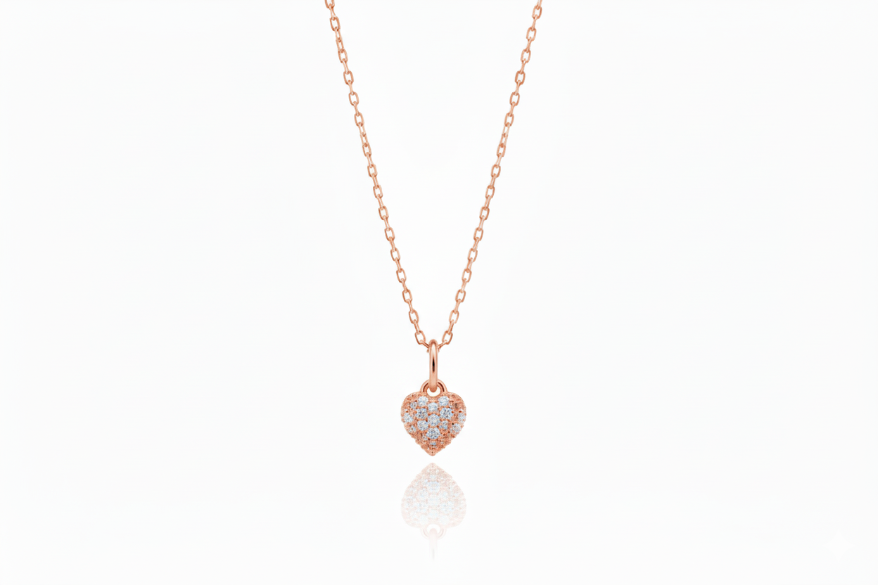 Rose gold necklace with a heart-shaped pendant on a white background