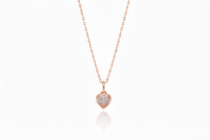 Rose gold necklace with a heart-shaped pendant on a white background