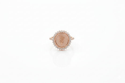 Rose gold ring with a circular design on a white background