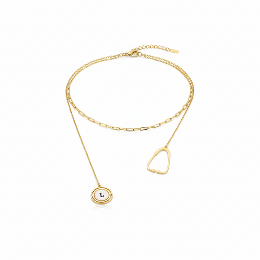 Gold stethoscope necklace with a small round pendant on a white background