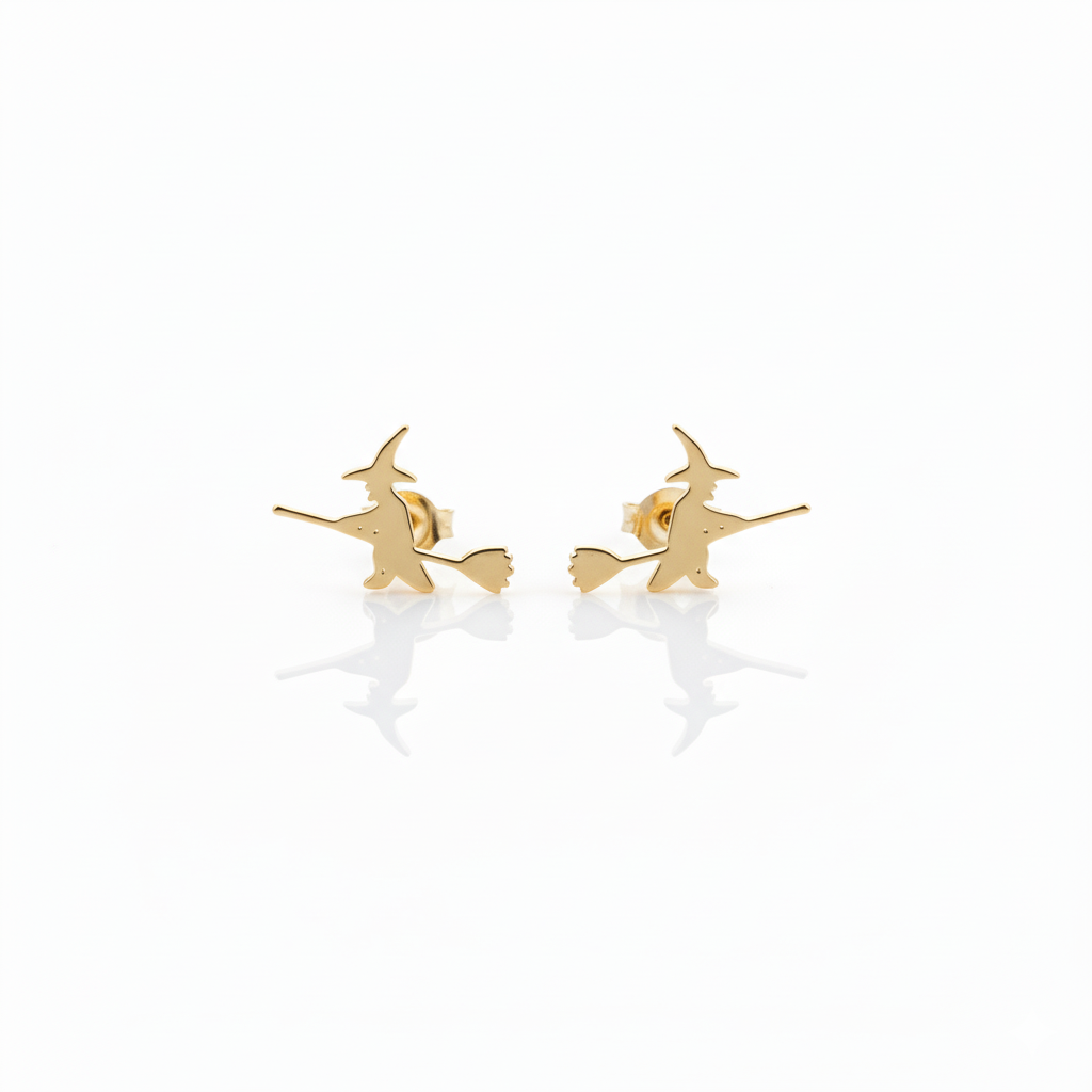 A close-up image of aa small gold stud earring with a witch design