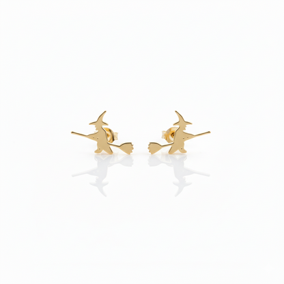 A close-up image of aa small gold stud earring with a witch design