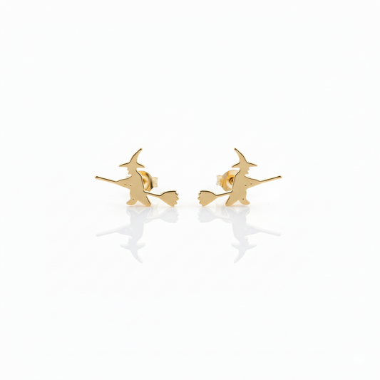 A close-up image of aa small gold stud earring with a witch design